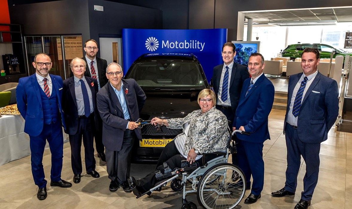 Rt Hon Robert Halfon handing over the keys to Johanna new Motability Scheme car. They are both smiling at the camera.